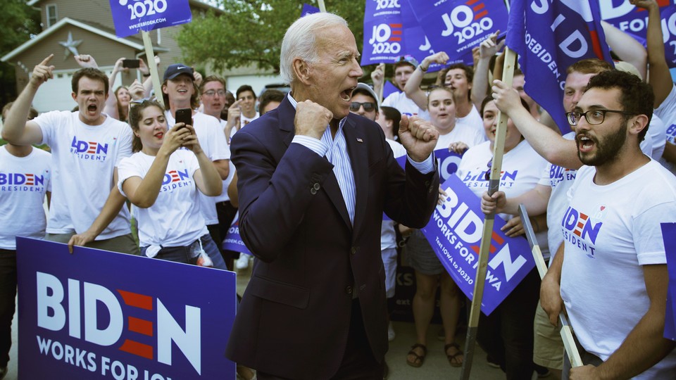 Joe Biden pumps his fists amid a group of young-adult supporters.