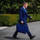 A color photograph of Michael Waltz crossing a driveway on the White House grounds.