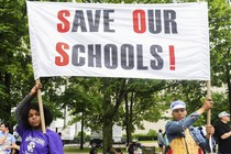 Students of the East Ramapo School District hold a sign that reads "Save our schools!" 