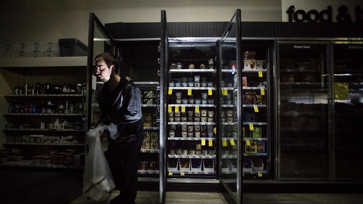 A darkened freezer section of a convenience store.