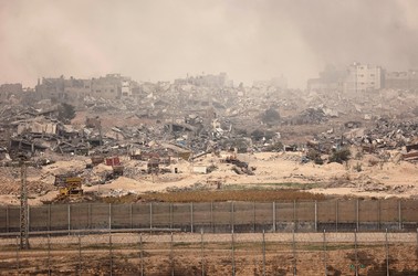 A view of smoking ruins in Gaza from the southern Israeli border