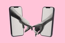 An image of two arms coming out of two phone screens, holding hands