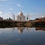 The Taj Mahal is reflected in a puddle.