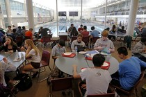 Students eat lunch in a cafeteria 