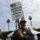 A Democratic Party worker holds up a "register to vote" sign.
