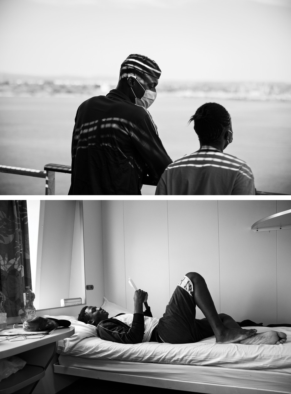 Two migrants conversing on the deck of a ship; a migrant lying on a bed in the ship's cabin