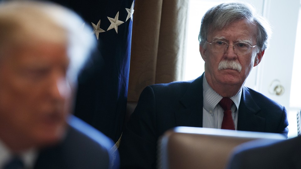 John Bolton looking at President Trump