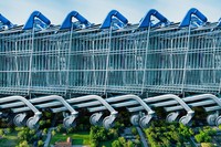 Giant shopping carts looming over a suburb