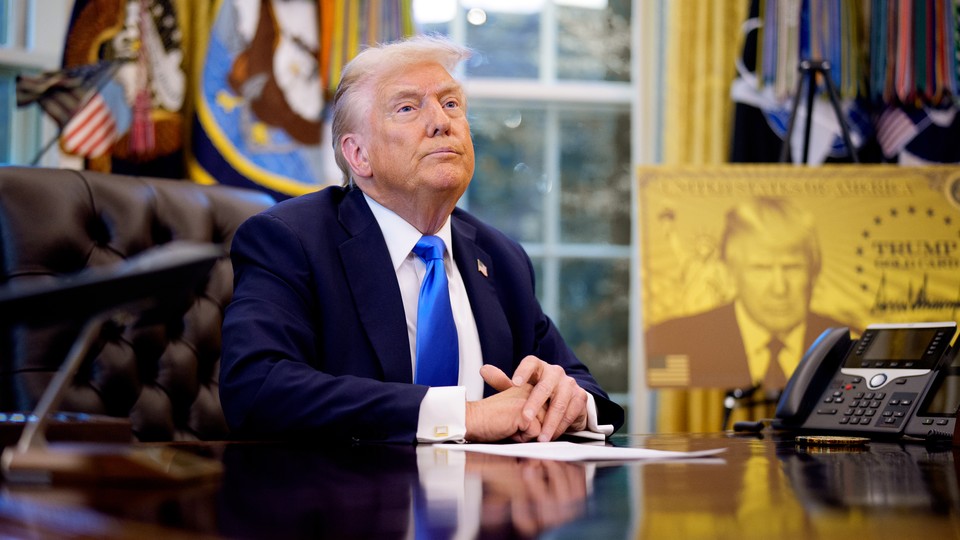 Trump with gold card poster behind