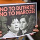 A person holding a sign reading "No to Duterte! No to Marcos!"