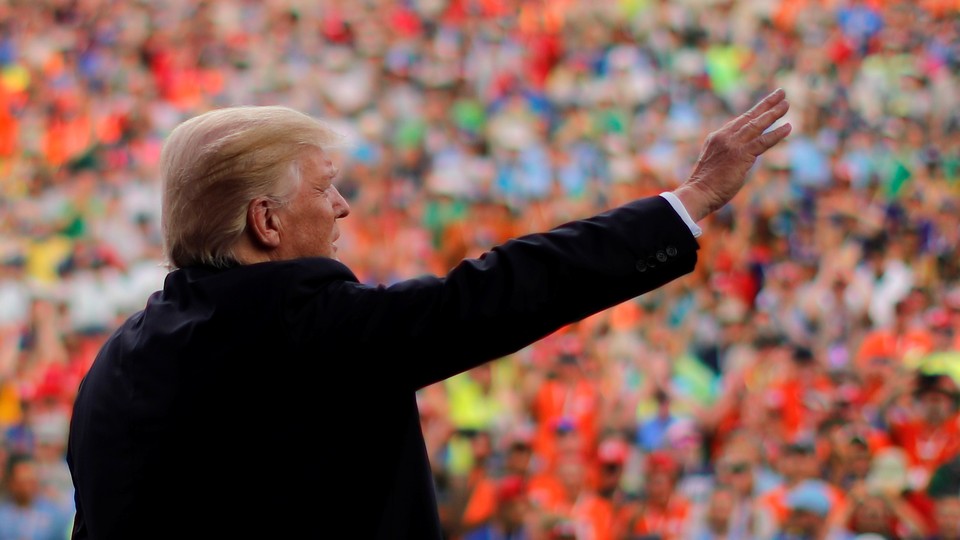 Donald Trump waves to a crowd of Boy Scouts.