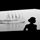 A woman posing in front of a cruise ship