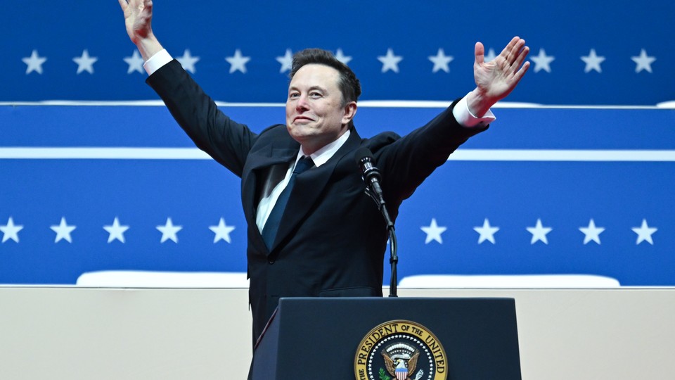 Elon Musk raises his arms in front of the presidential podium