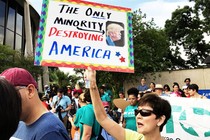 A protester carries an anti-Trump sign