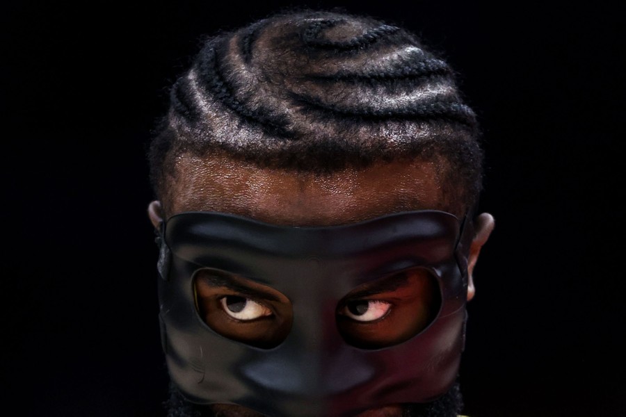 A close view of a masked basketball player during a game