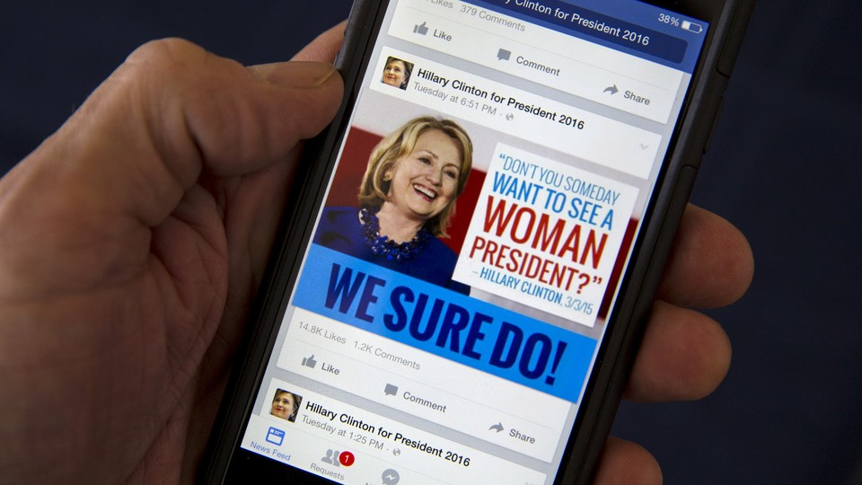 A mobile phone shows a Facebook page promoting Hillary Clinton for president in 2016.