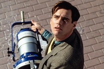 Jim Carrey as Truman Burbank, holding a klieg light that has just fallen from the sky in 'The Truman Show'
