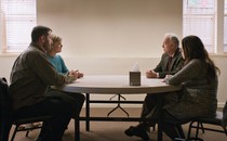 The four parents in "Mass" sit at a table.