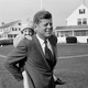 John F. Kennedy with his daughter on his back