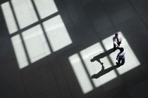 Two businessmen shake hands in a lobby