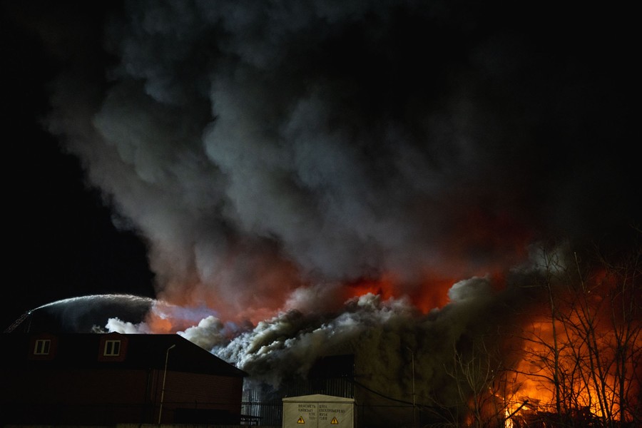 Black smoke rises from a burning building.