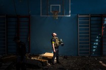 Ukrainian police officer standing in an empty gym