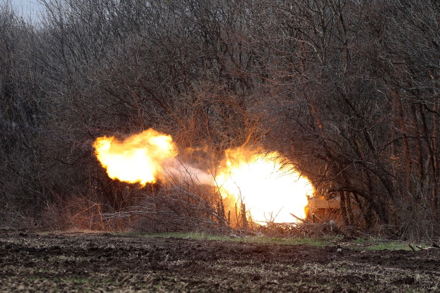 An explosion as a missile is fired from a forested area