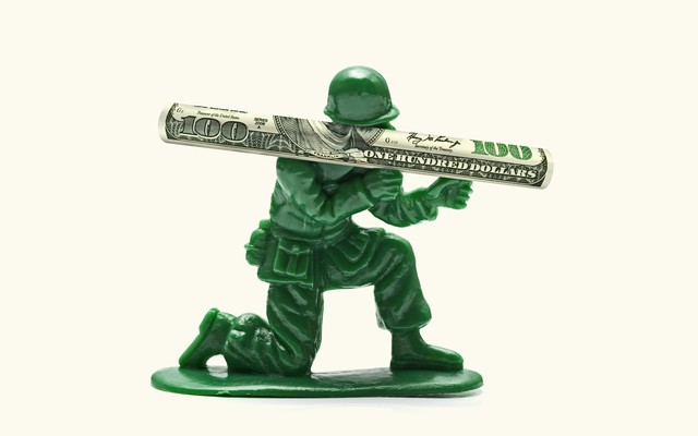 Artwork of a toy soldier wielding a rocket launcher made of a $100 bill