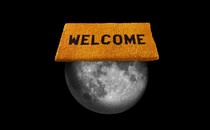 A picture of the moon with a giant orange "Welcome" sign sitting on top