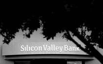 Black and white photo of Silicon Valley Bank branch partially covered by a tree.