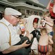 Grandparents drinking sodas with kids eating chips at the beach