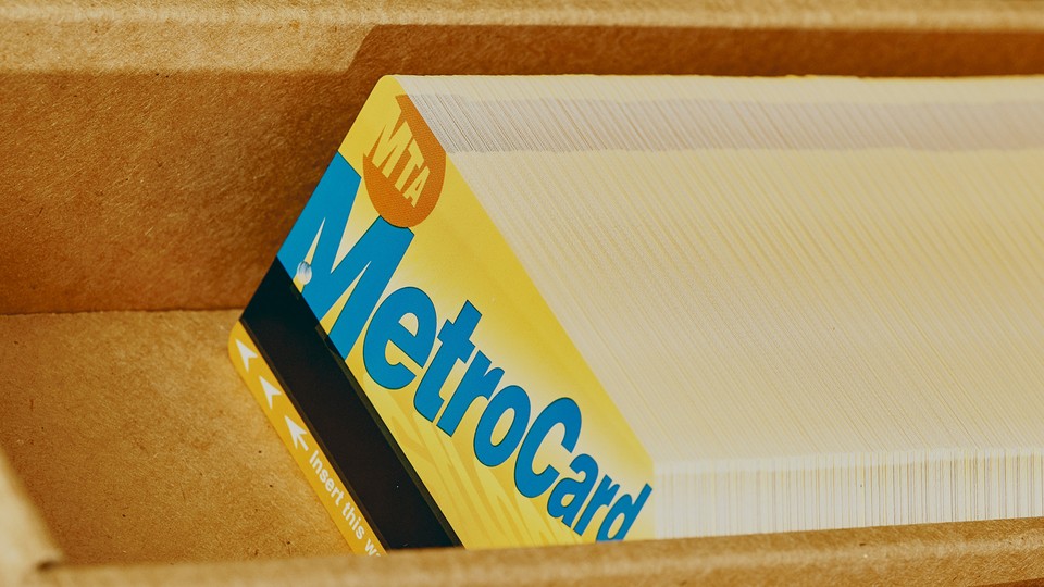 A stack of MTA metro cards in a cardboard box