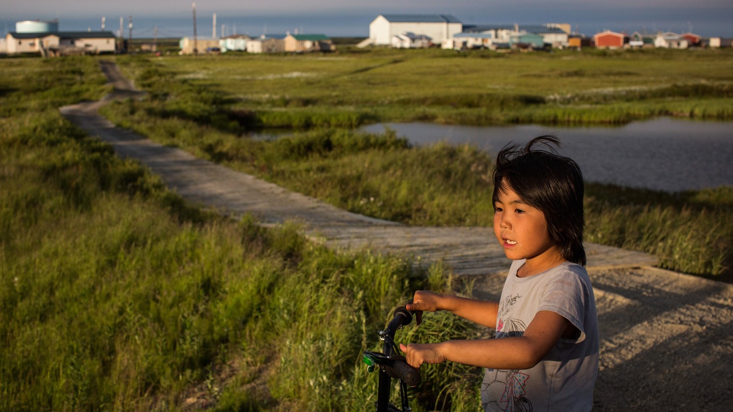 Group Of Children Walking On Sandy Road With Fishing Equipment