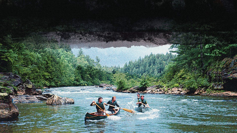 four men canoeing down a river
