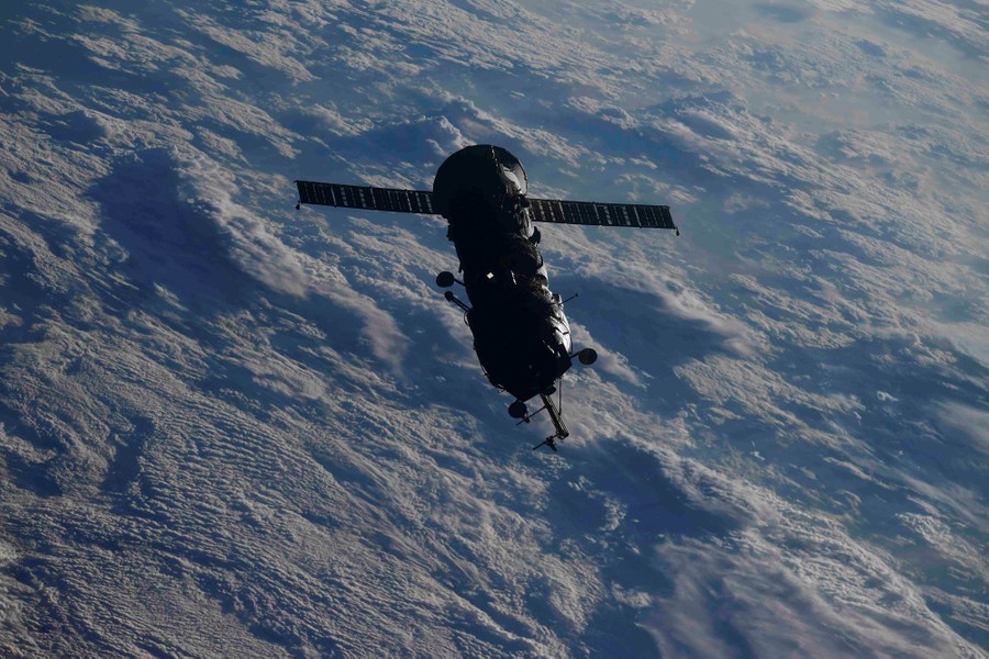 A spacecraft is seen in orbit above the Earth.