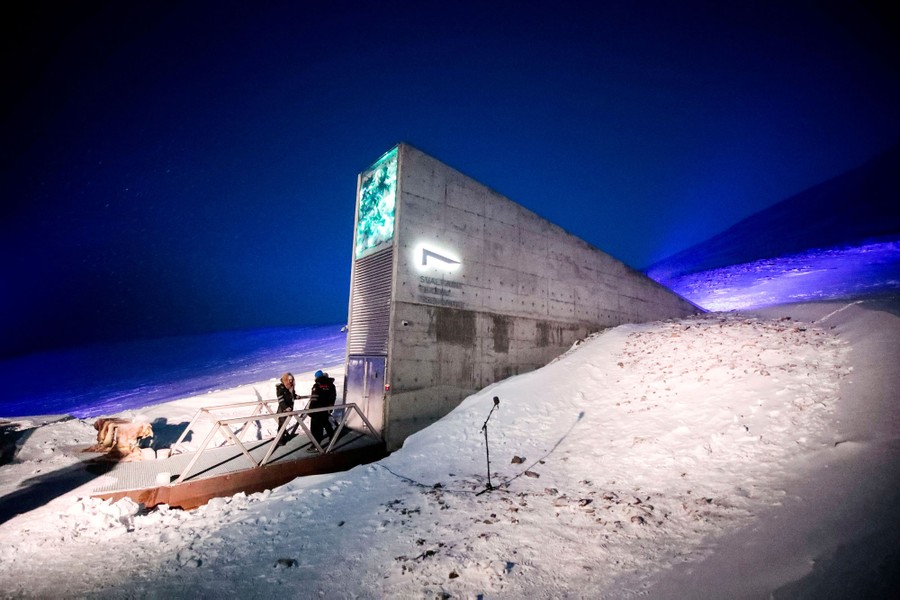 A view of a concrete entrance to an underground vault, surrounded by snow