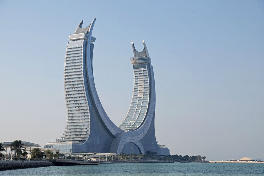 A view of a two-towered building shaped roughly in a semicircle