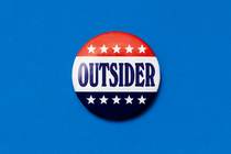 An illustration of a campaign button that says, 'Outsider'