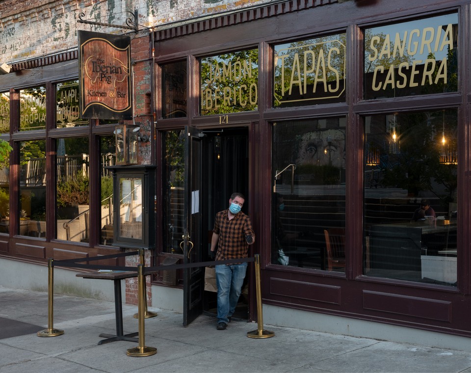 Employee running carry out for The Iberian Pig in Decatur. (Joshua Dudley Greer)