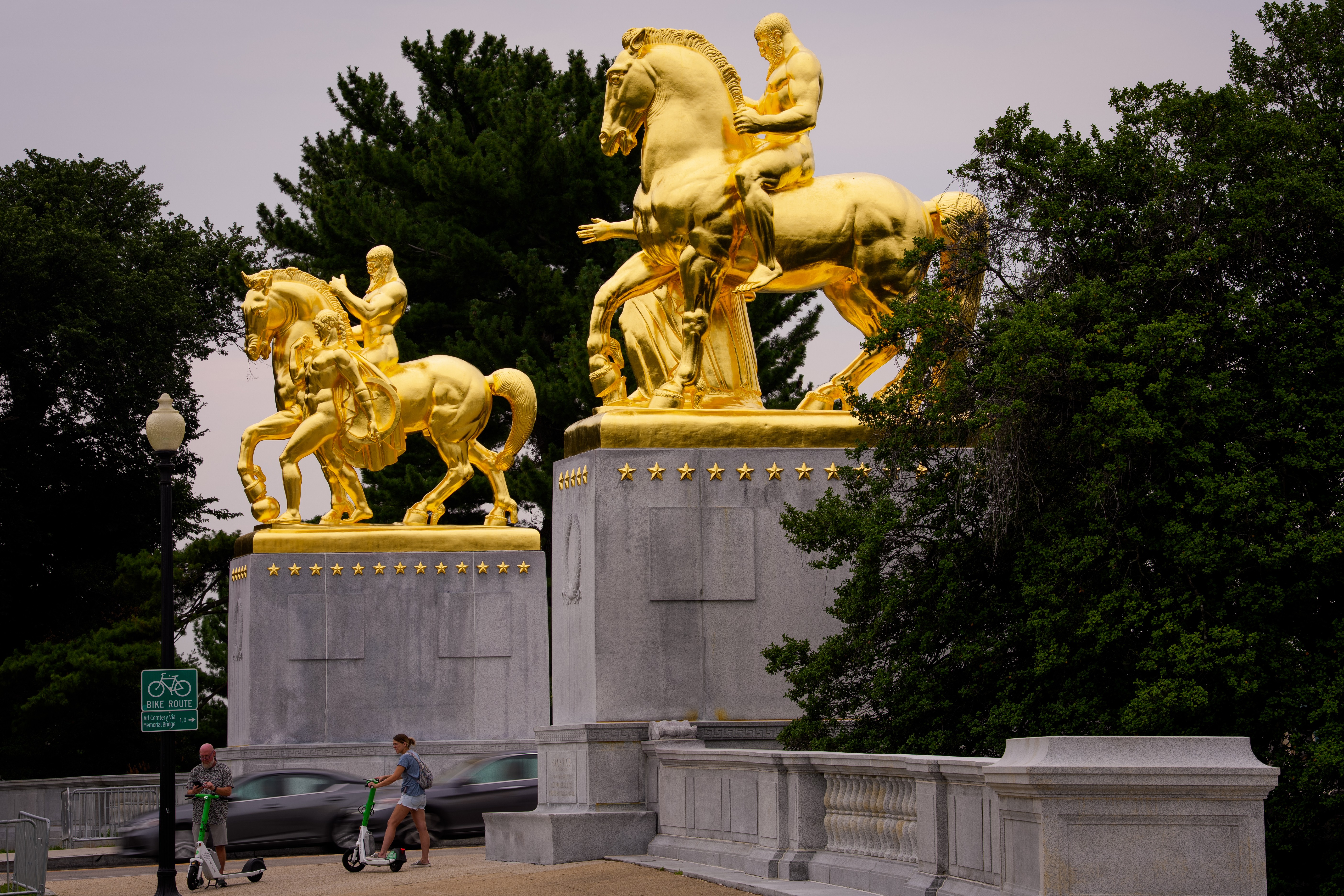 A pair of gold-covered equestrian statues on a bridge in Washington, D.C.