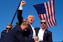 Donald Trump with blood on his face, raising his fist, after an assassination attempt at his rally