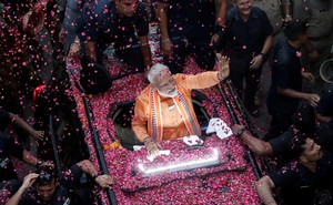 Narendra Modi waves to supporters in Varanasi in April.
