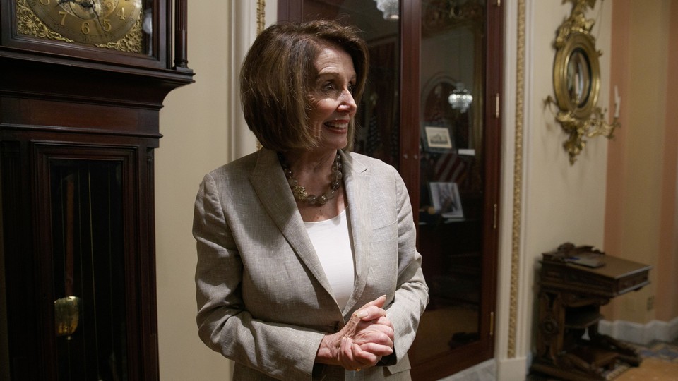 Nancy Pelosi smiling with clasped hands
