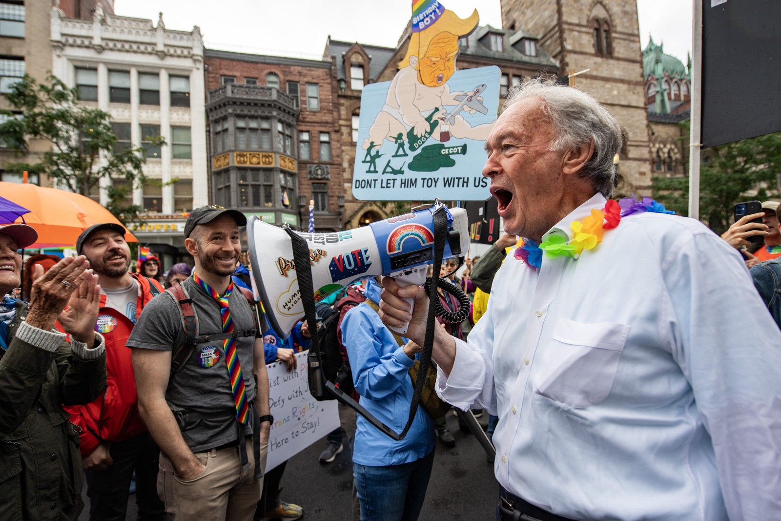U.S. Senator Ed Markey speaks to demonstrators, using a bullhorn.