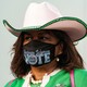 A woman wearing a mask that says "Vote"