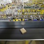 A cardboard box on a conveyor belt inside a warehouse