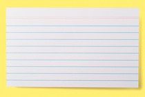 A lined index card on a yellow background