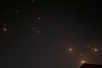 Iranian projectiles streak across the night sky.