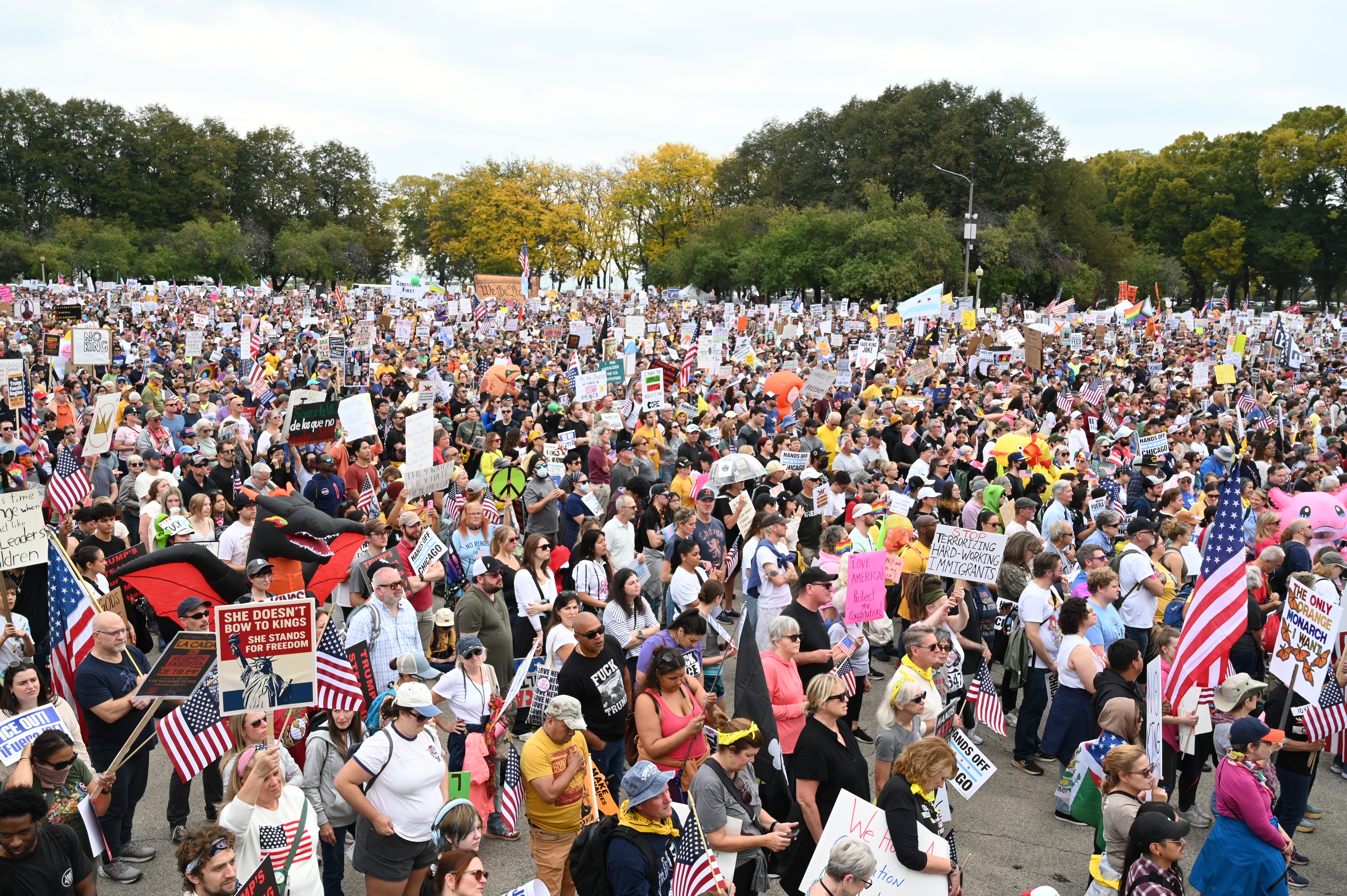 An elevated view of a large crowd of protesters in a square in Chicago.
