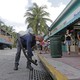 A mosquito control inspector sprays a chemical mist into a storm drain in Miami Beach, Florida, on August 23, 2016.